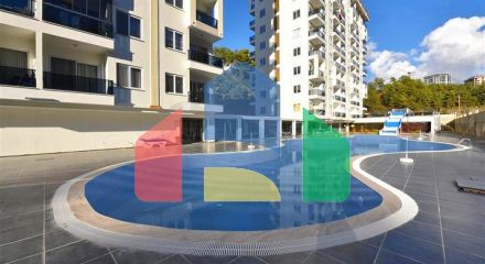 Двокімнатна квартира 1 + 1 в зеленій частині району Авсаллар з багатою інфраструктурою